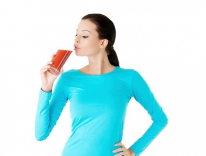 Woman drinking tomato juice